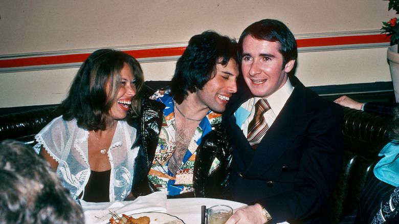 Freddie Mercury en una festa, assegut i rient