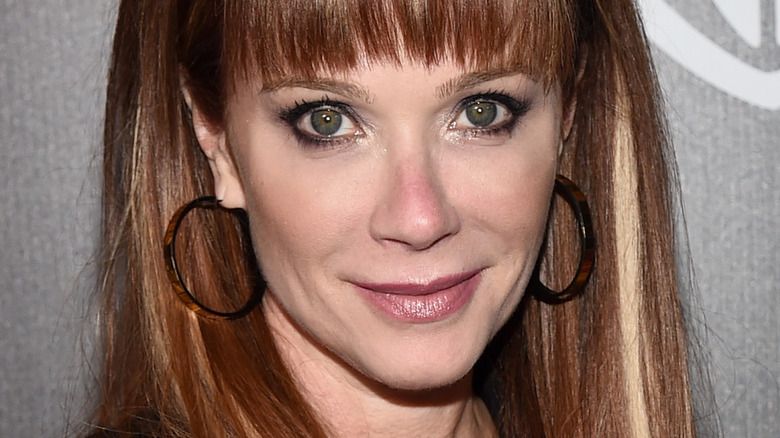 Η Lauren Holly χαμογελά στην κάμερα με κτυπήματα